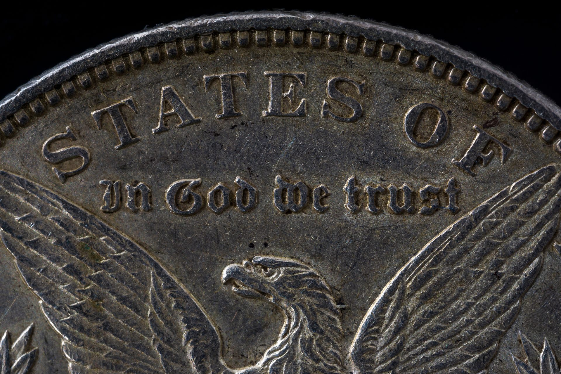 Macro detail of a Morgan Silver Dollar reverse showing the eagle and In God We Trust